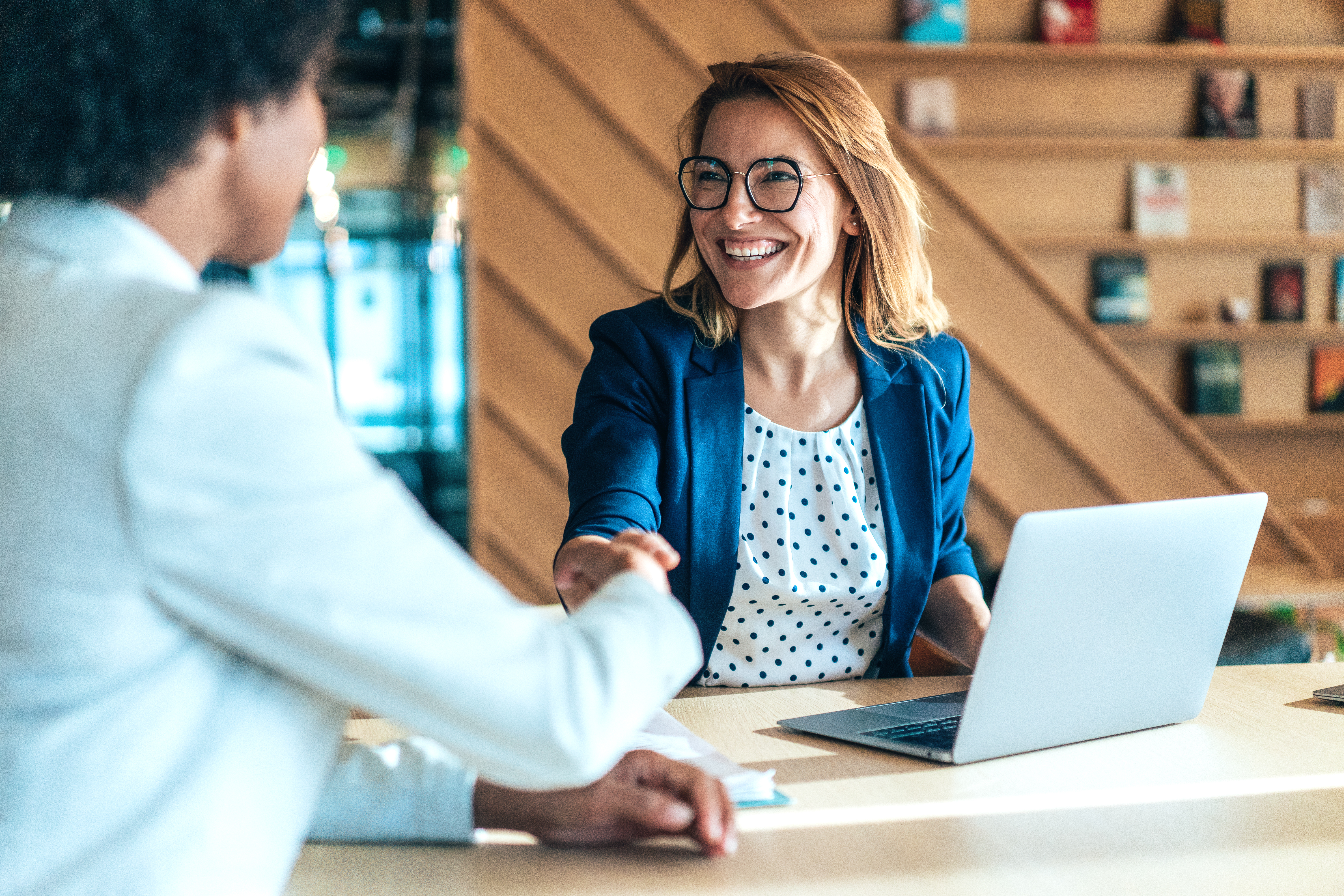 Smiling business woman shaking hands